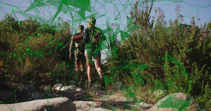 Climbing two hikers ascending rocky hillside trail under blue sky, with backpacks, network overlay