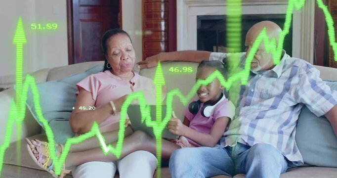 Three-generation family tapping tablet and showing financial chart overlay for market insights