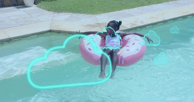 Child noticing AR clouds, reaching toward them for interacting and rotating donut float in pool