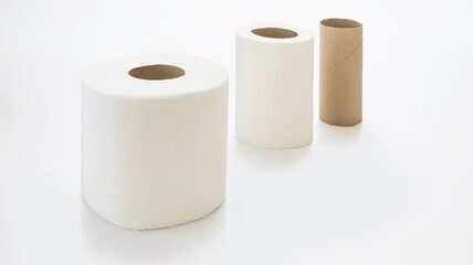 Close up of rolls of toilet paper and one empty 