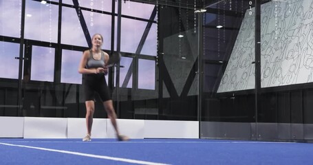 female player bracing incoming ball on padel court, code overlay guiding swinging forehand drills - Powered by Adobe