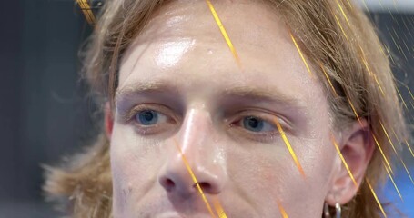 Man tilting head right in tech demo activating golden streak flowing across face for glitch effect - Powered by Adobe
