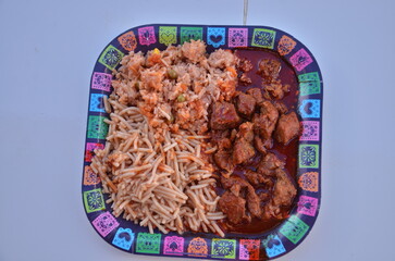 Authentic fiesta feast featuring delicious carne guisada, spaghetti, and rice, perfect for celebrating Dia de los Muertos with vibrant cultural flair