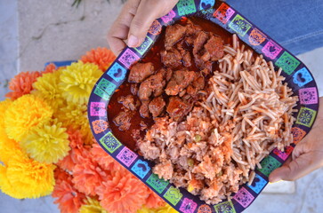 Authentic fiesta feast featuring delicious carne guisada, spaghetti, and rice, perfect for celebrating Dia de los Muertos with vibrant cultural flair