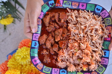Authentic fiesta feast featuring delicious carne guisada, spaghetti, and rice, perfect for celebrating Dia de los Muertos with vibrant cultural flair