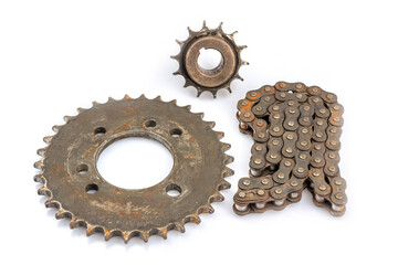 Close up of dirty, oily and greasy old motorcycle chain and sprocket set on white background. The image reflects the essence of repair, maintenance