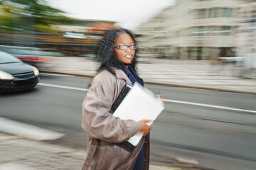 Portrait of a young business woman in dunamic movement outside. social media, successful, communication concept.