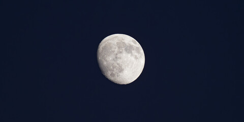 Detailed Waxing Gibbous Moon Against a Deep Blue Night Sky
