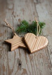 Wooden star and heart ornaments with greenery on rustic wooden background