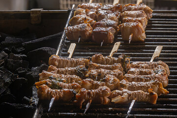 Typical apulian skewers of lamb meat and offal called fegatini on a charcoal barbecue