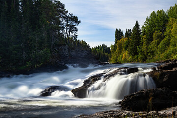 Wild white water river rapids long exposure near Ristafallet waterfall in Sweden