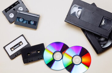 Retro acoustic, audio cassette tape, black video tape cassette, CD disc. Saving data, music, movies, videos. Vintage media concept. Top view