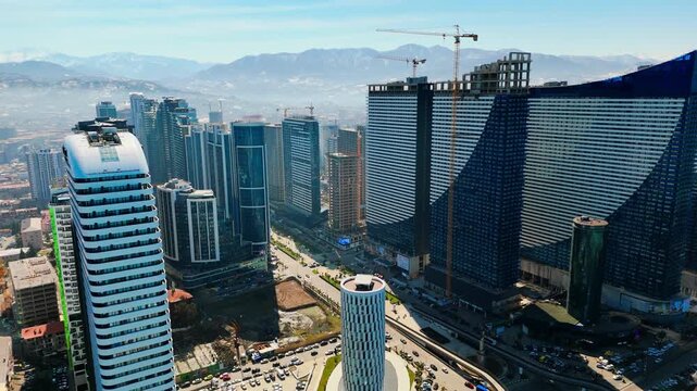 Aerial view of Batumi downtown with skyscrapers, Drone flight forward