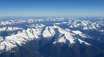 Naklejka premium Breathtaking Aerial View of Vast Snow capped Mountain Range on Sunny Day