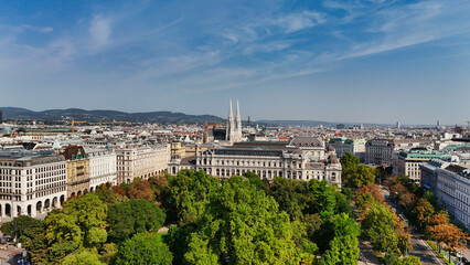Fototapeta premium Votivkirche (Votive Church) Spires and Vienna Cityscape from Above, Aerial View