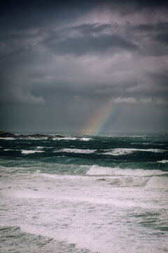 Dramatic Stormy Sea with Rainbow and Dark Skies
