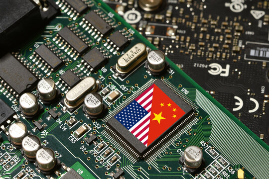 Flag of the United States and Republic of China on microchip of a PC Motherboard. Concept for world supremacy in microchip and semiconductor manufacturing.