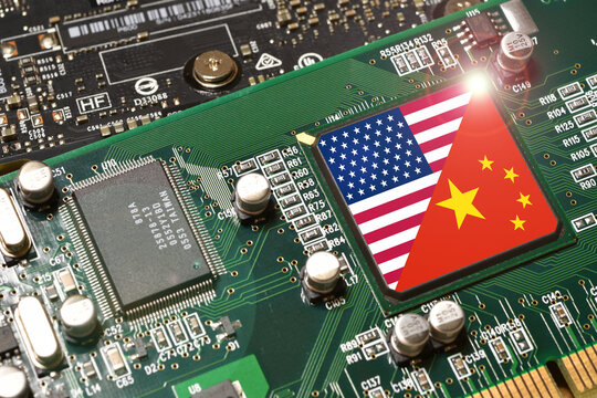 Flag of the United States and Republic of China on microchip of a PC Motherboard. Concept for world supremacy in microchip and semiconductor manufacturing.