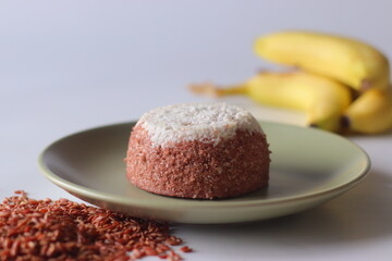 Navara rice puttu. Dome shaped steamed rice cake with Navara rice grains and grated coconut topping