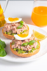 Two delicious tuna open sandwiches with avocado and boiled eggs. Tuna toast.