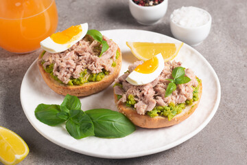Two delicious tuna open sandwiches with avocado and boiled eggs. Tuna toast.