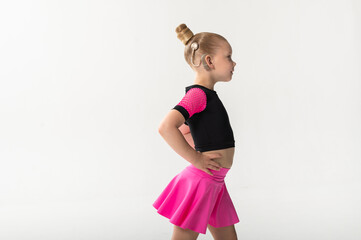 Girl with cochlear implant in dance pose, copy space. Symbol of resilience, equality, and artistic...