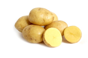 There are a lot of raw potatoes on a white background.	