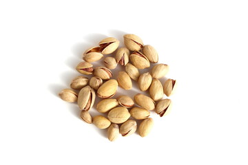There is a pile of pistachio nuts on a white background.