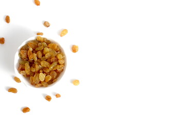 There is a white bowl with yellow raisins on a white background.