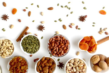 On a white background there are many different plates with different nuts.