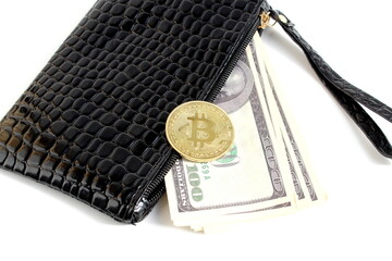 On a white background lies a black wallet souvenir coin bitcoin.	