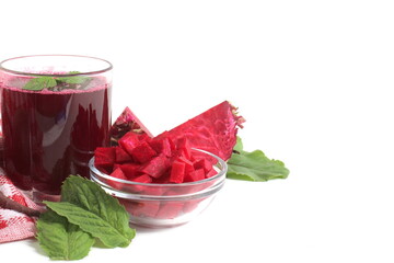 On a white bacOn a white background there is a glass of beetroot juice with beets.kground there are peat cups with soil.