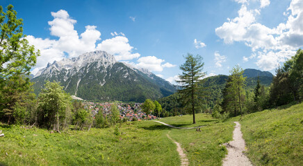 lookout place above Mittenwald, with bench and pilgrimage cross. Karwendel mountains.