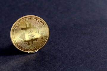 There is a souvenir bitcoin coin on a black background.