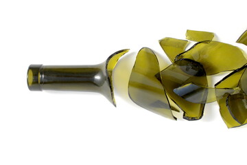 There is a broken green wine bottle lying on a white background.