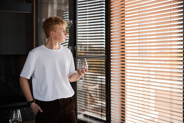 Expressive portrait of young man with somber mood and artistic