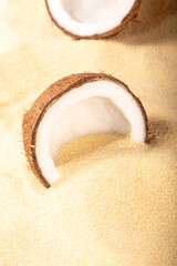 Cracked coconuts on sandy beach. Minimal summer tropical concept.