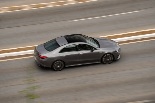 Grey Mercedes CLA coupe sedan, Panning shot, luxury car in motion