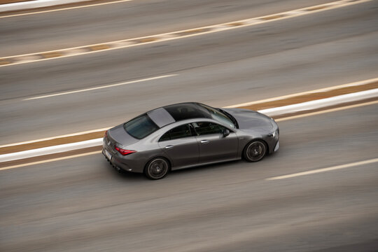 Grey Mercedes CLA coupe sedan, Panning shot, luxury car in motion