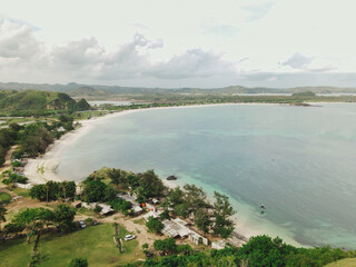 The coastal view is surrounded by enchanting green hills, including Merese Hill, which offers a spectacular viewpoint to enjoy the scenery. LOMBOK, NTB , INDONESIA