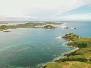 The coastal view is surrounded by enchanting green hills, including Merese Hill, which offers a spectacular viewpoint to enjoy the scenery. LOMBOK, NTB , INDONESIA