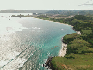 The coastal view is surrounded by enchanting green hills, including Merese Hill, which offers a spectacular viewpoint to enjoy the scenery. LOMBOK, NTB , INDONESIA
