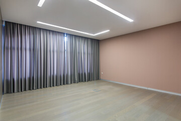 An empty office space in pastel colors with beautiful curtains on a large window.