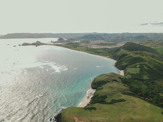 The coastal view is surrounded by enchanting green hills, including Merese Hill, which offers a spectacular viewpoint to enjoy the scenery. LOMBOK, NTB , INDONESIA
