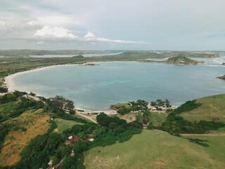 The coastal view is surrounded by enchanting green hills, including Merese Hill, which offers a spectacular viewpoint to enjoy the scenery. LOMBOK, NTB , INDONESIA