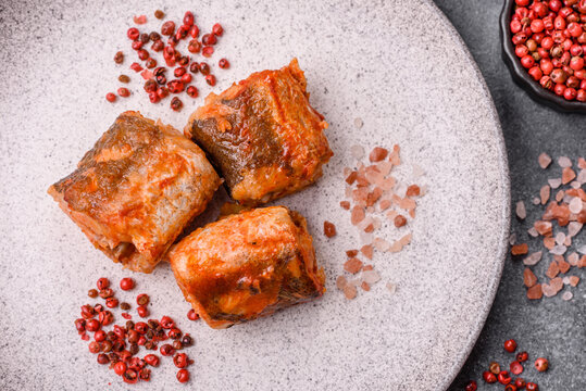 Hake fish cooked in pieces in tomato sauce, stew with peppers and carrots. Hake fish in tomato
