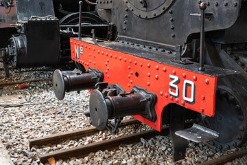Spain – Detail of an old coal-powered locomotive on display, showcasing its vintage machinery and industrial heritage under natural daylight. © kalama