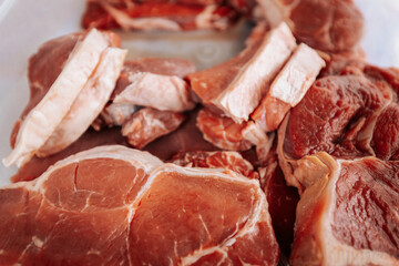 A close-up of raw, marbled beef cuts, showcasing rich red color and fat layers, ready for grilling or cooking in a farm-to-table experience.