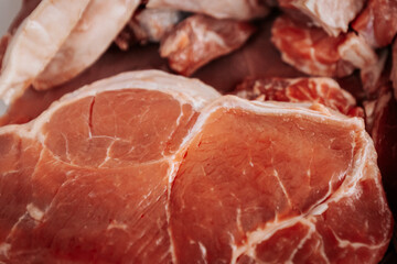 A close-up of raw, marbled beef cuts, showcasing rich red color and fat layers, ready for grilling or cooking in a farm-to-table experience.