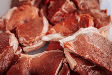 A close-up of raw, marbled beef cuts, showcasing rich red color and fat layers, ready for grilling...